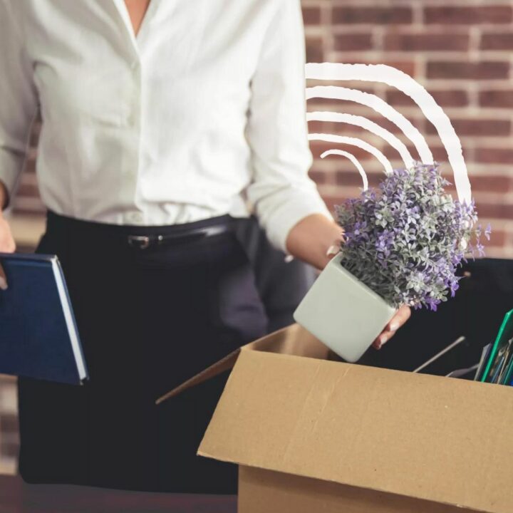 Female professional packing up the things in her office into a brown box