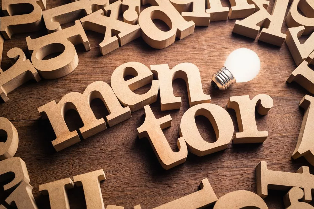 The word "mentor" with a light bulb