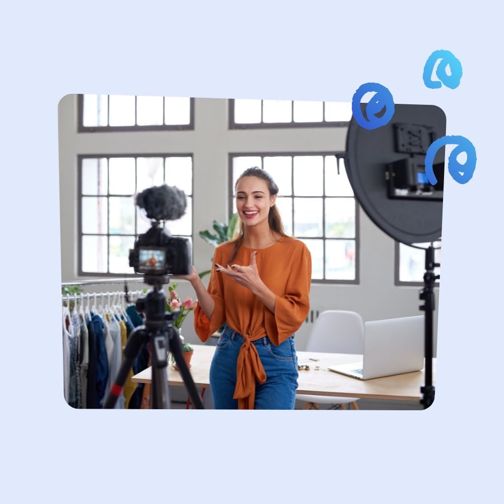 Young woman filming a video in a bright, modern workspace, speaking confidently in front of a camera, with professional lighting setup, creating content for social media.