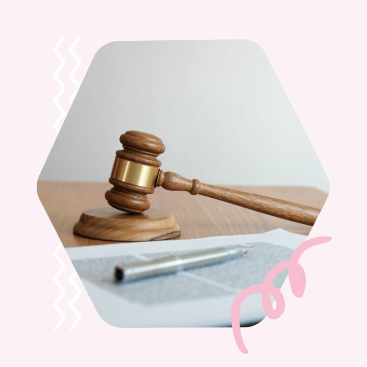 Close-up of a wooden judge's gavel resting on a document, with a pen nearby, symbolizing legal proceedings or decision-making related to a new job or employment.