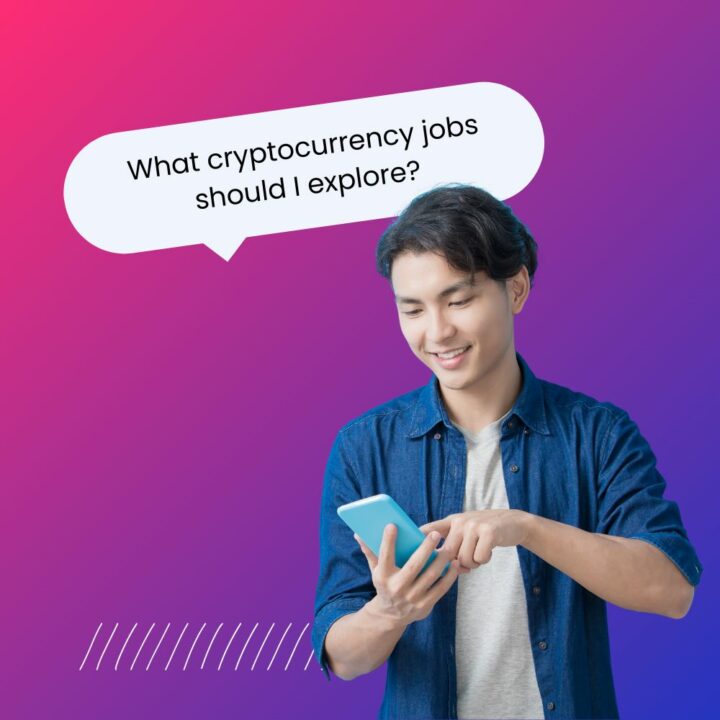 A young man smiling as he interacts with his smartphone, wearing a casual denim shirt over a light-colored t-shirt. A speech bubble above him reads, 'What cryptocurrency jobs should I explore?'