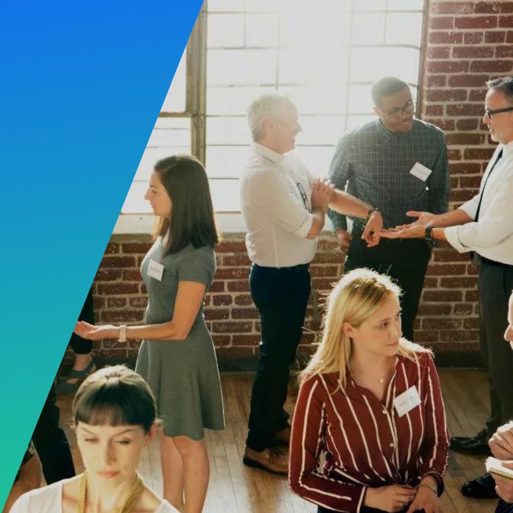 Business people at a professional organization meetup mingling with name tags on