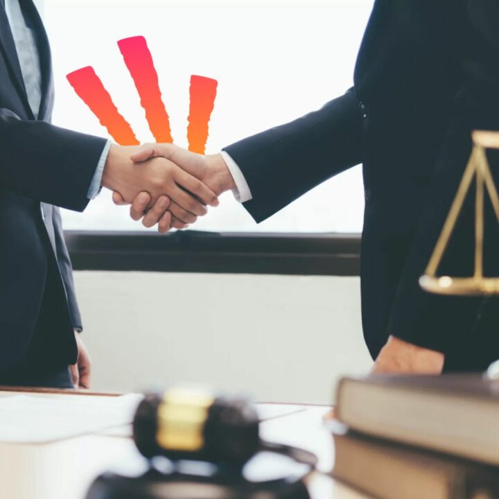 Two legal professionals shaking hands