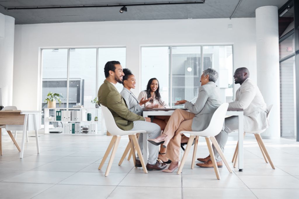 Collaboration and group of diverse professional employees in various in-demand jobs having a business meeting in a modern office