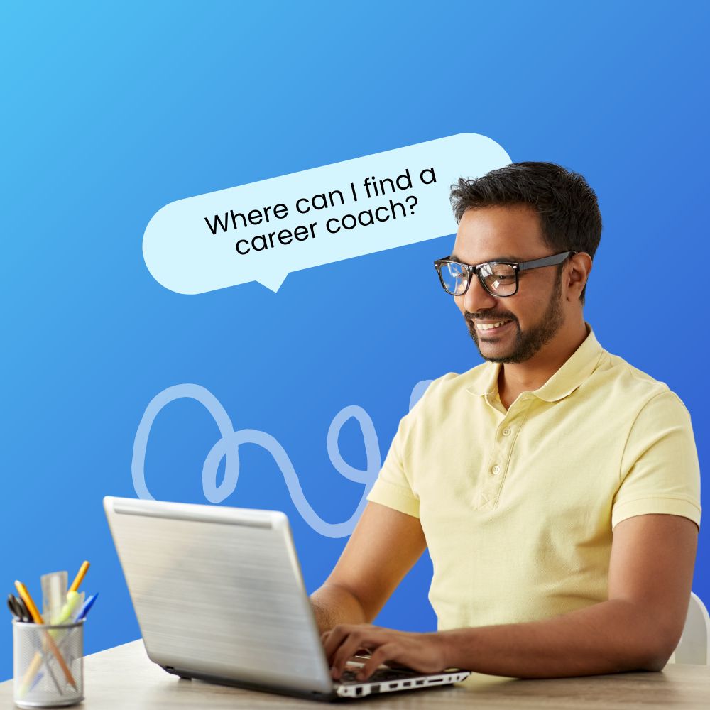 A young man wearing glasses and a light yellow polo shirt is sitting at a desk, smiling while working on his laptop. A speech bubble above his head reads, "Where can I find a career coach?