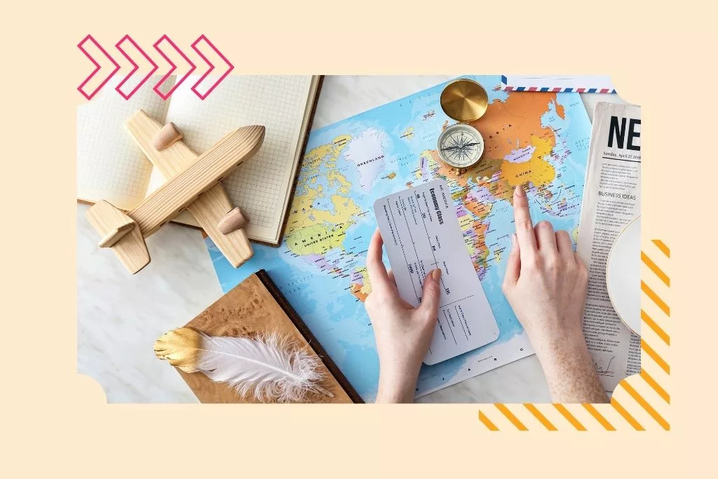 College graduate pointing at china on a world map showing where they are going to work abroad. Wooden plane on a notebook and a compass on the world map.
