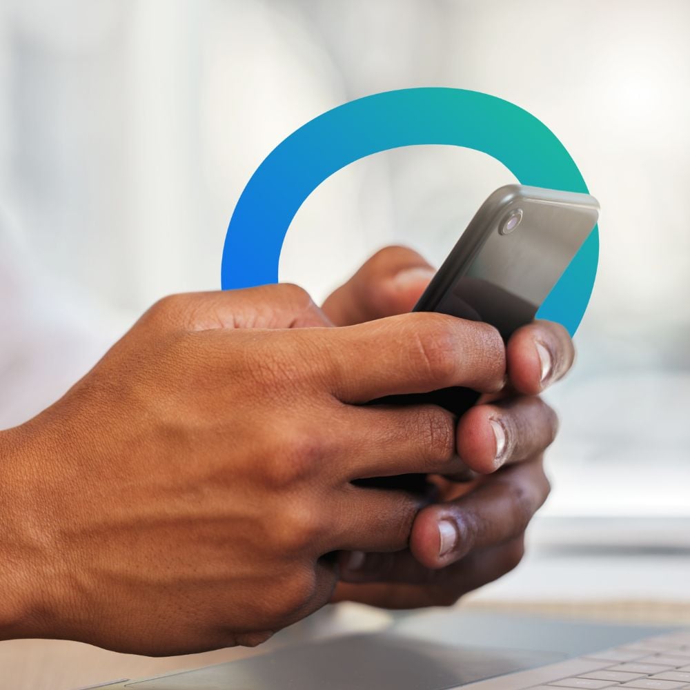 Close-up of a person's hands holding a smartphone. The person is typing or interacting with the phone on LinkedIn