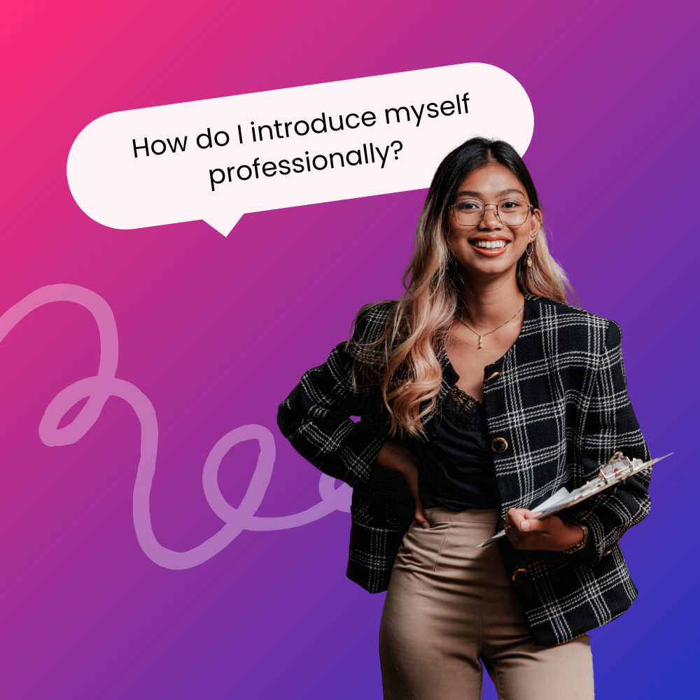 A young professional woman with long, wavy hair and glasses smiles confidently while holding a clipboard. She is dressed in a plaid blazer over a black top and beige pants, standing against a vibrant pink and purple gradient background. Above her, a speech bubble reads, 'How do I introduce myself professionally?'